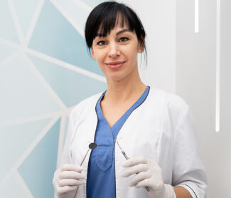 dentist dental equipment in her hands and smiling