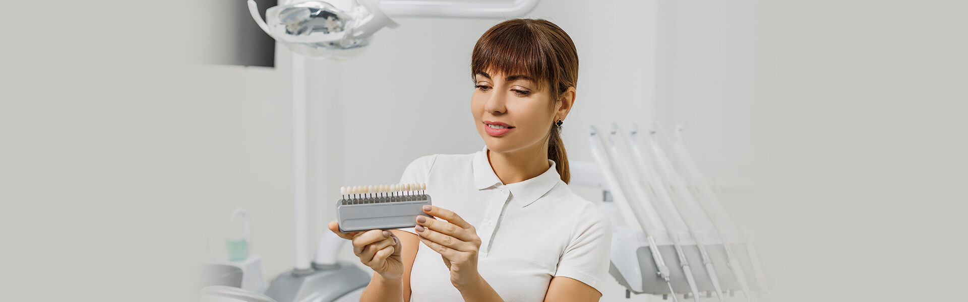 girl holding veneers in her hands