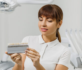 girl holding veneers in her hands