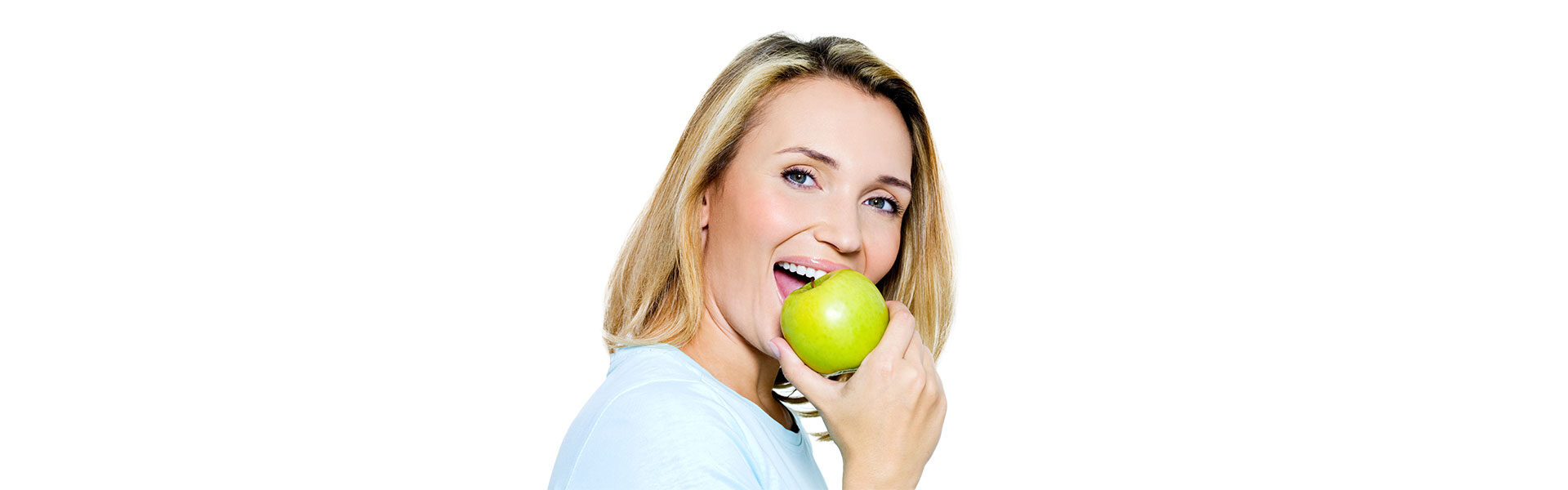 girl holding apple near her mouth