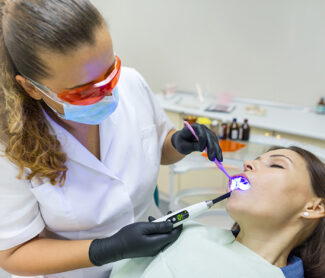 dentist is examine girl mouth