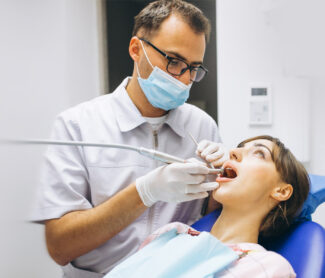 dentist checking lady's mouth